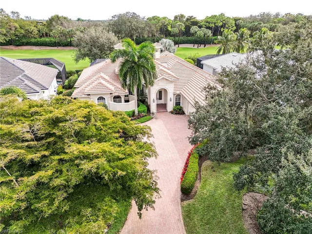 a aerial view of a house with pool and a yard