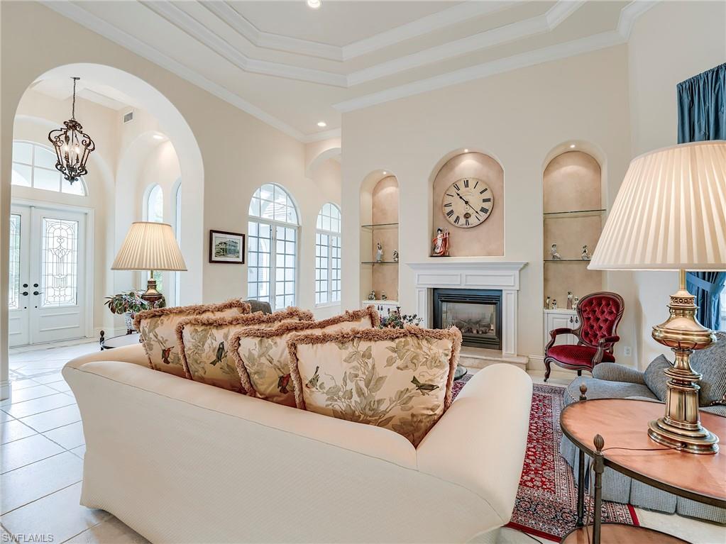 10128 Idle Pine Lane Estero, FL 34135 - Photo 12 of 50 a living room with fireplace furniture and a large window