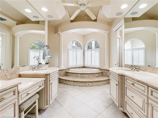 a spacious bathroom with a granite countertop sink and a mirror