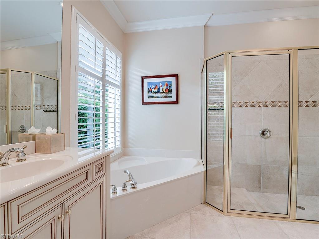 10128 Idle Pine Lane Estero, FL 34135 - Photo 26 of 50 a bathroom with a tub sink and shower