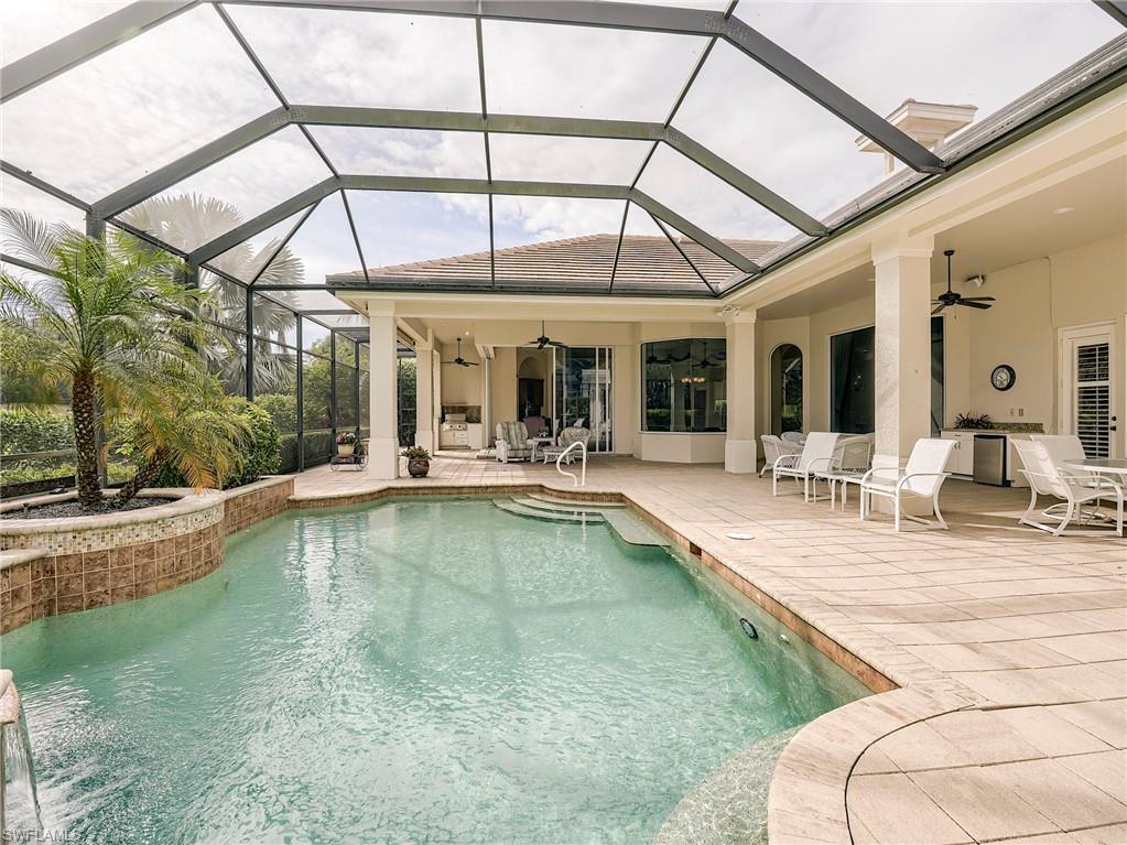10128 Idle Pine Lane Estero, FL 34135 - Photo 28 of 50 a view of a patio with a table and chairs