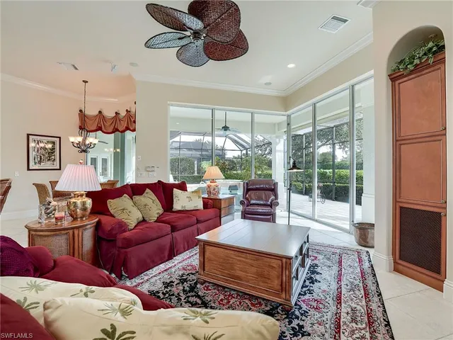 a living room with furniture ceiling fan and a rug