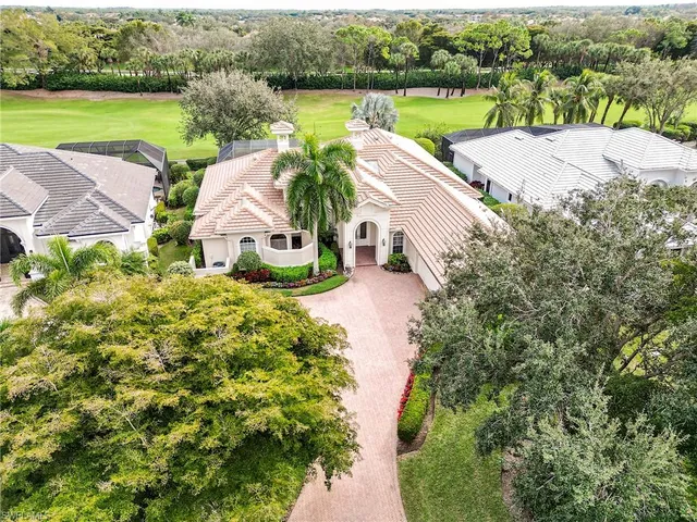 an aerial view of house with yard and lake view