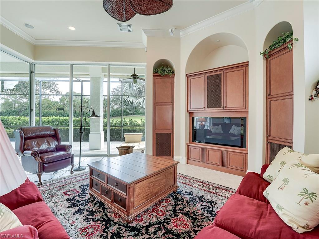 10128 Idle Pine Lane Estero, FL 34135 - Photo 4 of 50 a living room with furniture and a floor to ceiling window