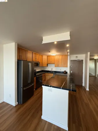 a kitchen with a refrigerator sink and cabinets