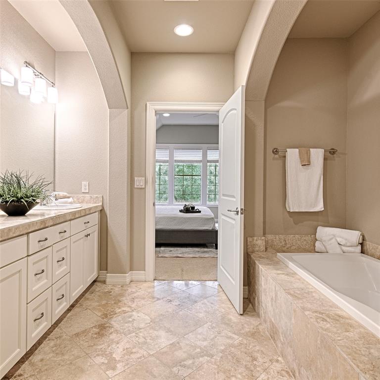 6269 Oram Street, Unit 10 Dallas, TX 75214 - Photo 22 of 25 a spacious bathroom with a double vanity sink a mirror and a shower