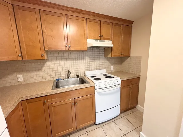 a view of a kitchen with sink and cabinets