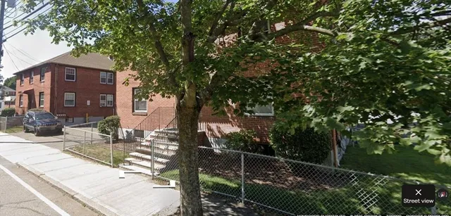 a backyard of a house with table and chairs