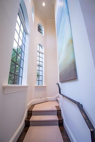 a spacious bedroom with a large bed and wooden floor