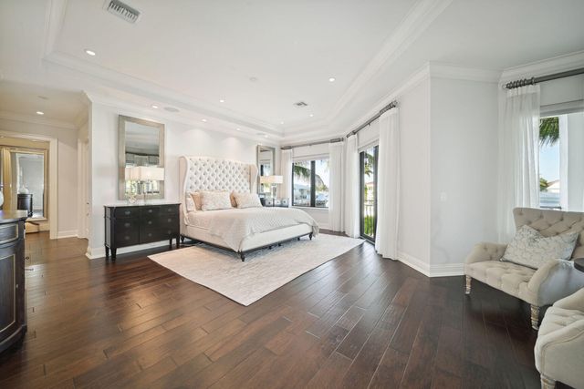 a bedroom with a large bed and a wooden floor
