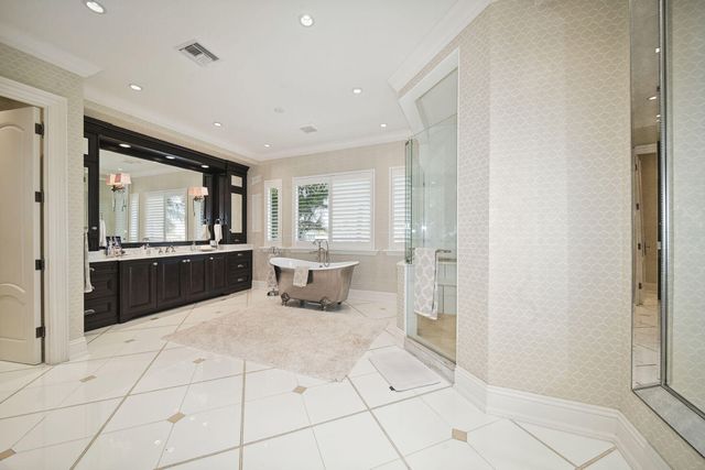 a spacious bedroom with a bed and a chandelier