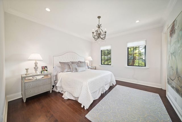 a bedroom with a large bed and wooden floor