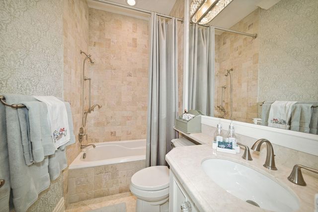 a bed sitting in a spacious bedroom next to a window