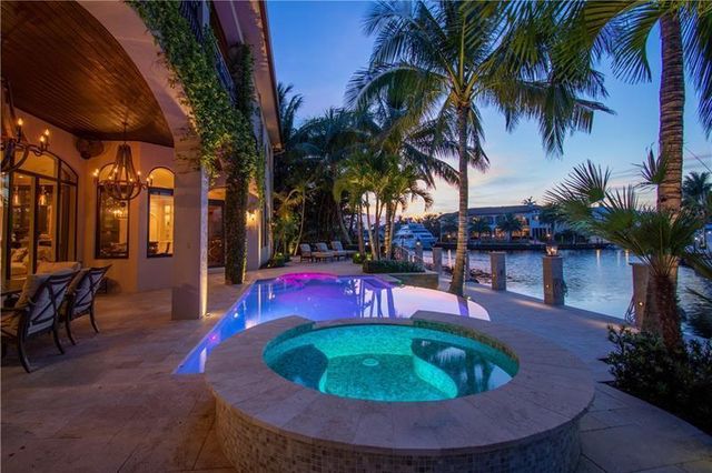 a swimming pool with outdoor seating and yard