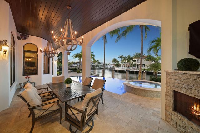 a view of a patio with couches and table and chairs and potted plants