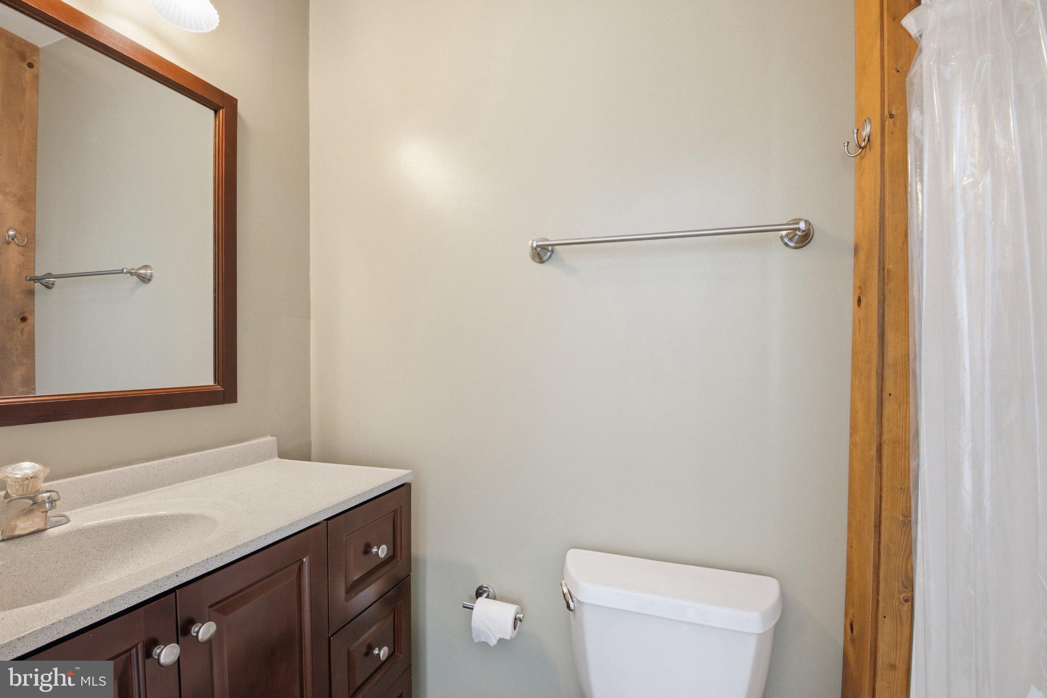 1469 Cedarhurst Road Shady Side, MD 20764 - Photo 13 of 19 a bathroom with a granite countertop sink toilet and shower
