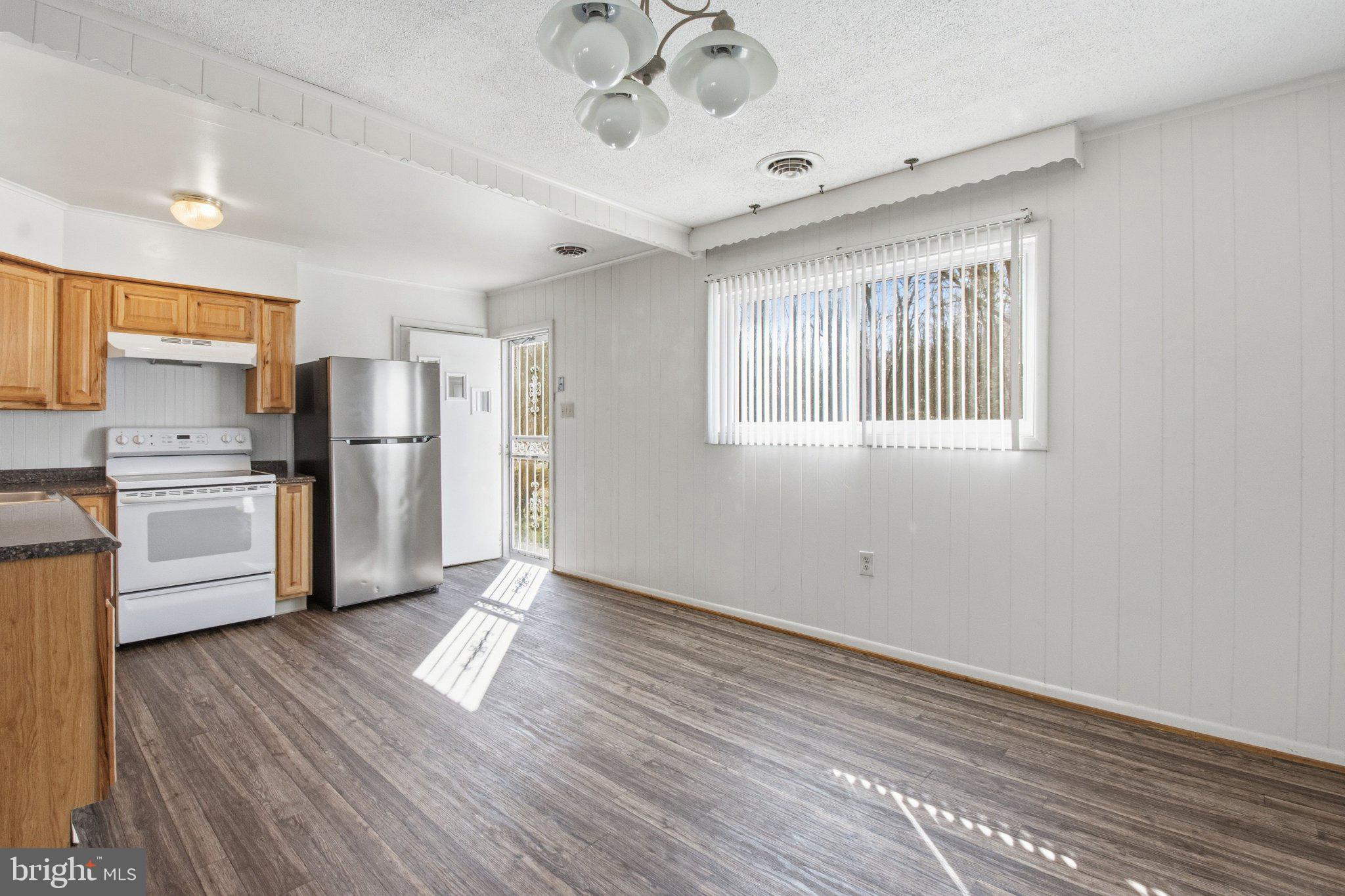 1469 Cedarhurst Road Shady Side, MD 20764 - Photo 7 of 19 a kitchen with stainless steel appliances a refrigerator and a stove top oven
