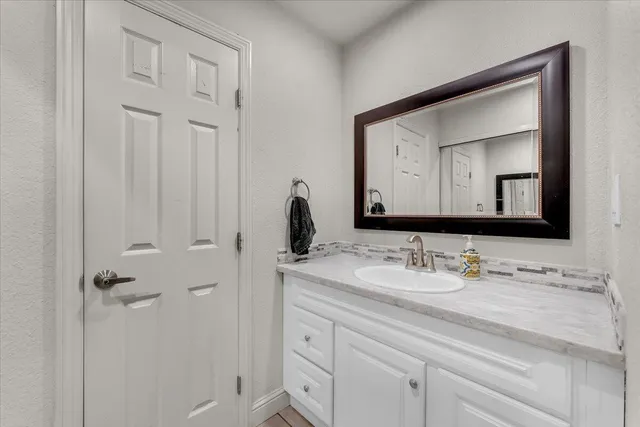 a bathroom with a sink vanity and a mirror