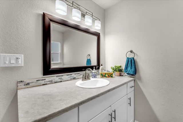 a bathroom with a sink and a mirror