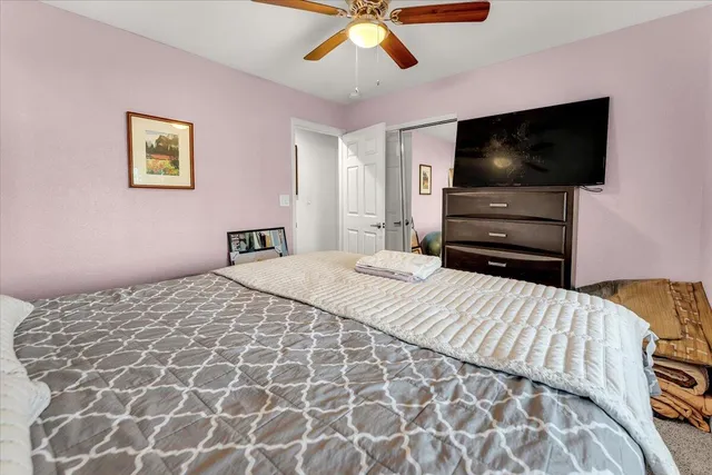 a bedroom with a bed and a flat screen tv