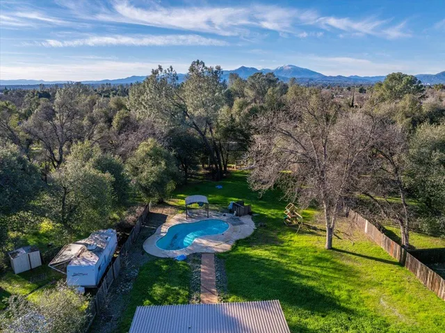 a view of a garden with a table and a fire pit