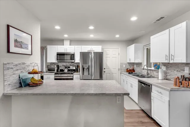 a kitchen with refrigerator a sink and cabinets