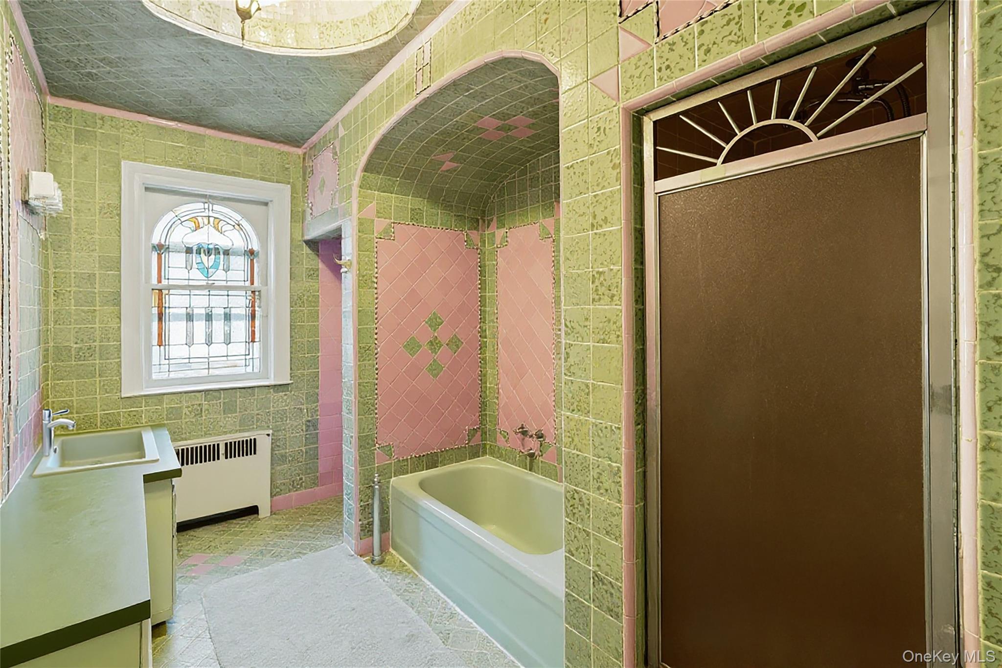 1527 East 29th Street Brooklyn, NY 11229 - Photo 13 of 22 Full bathroom with tile walls, a garden tub, vanity, radiator, and a shower with shower door
