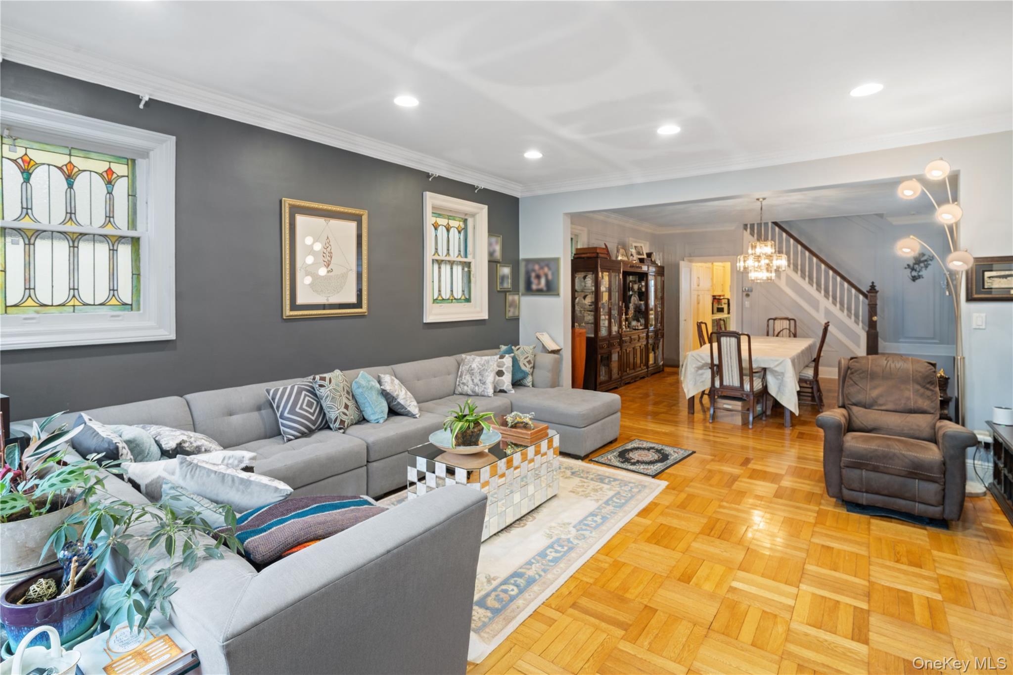 1527 East 29th Street Brooklyn, NY 11229 - Photo 3 of 22 Living area featuring crown molding, recessed lighting, stairway, and a chandelier