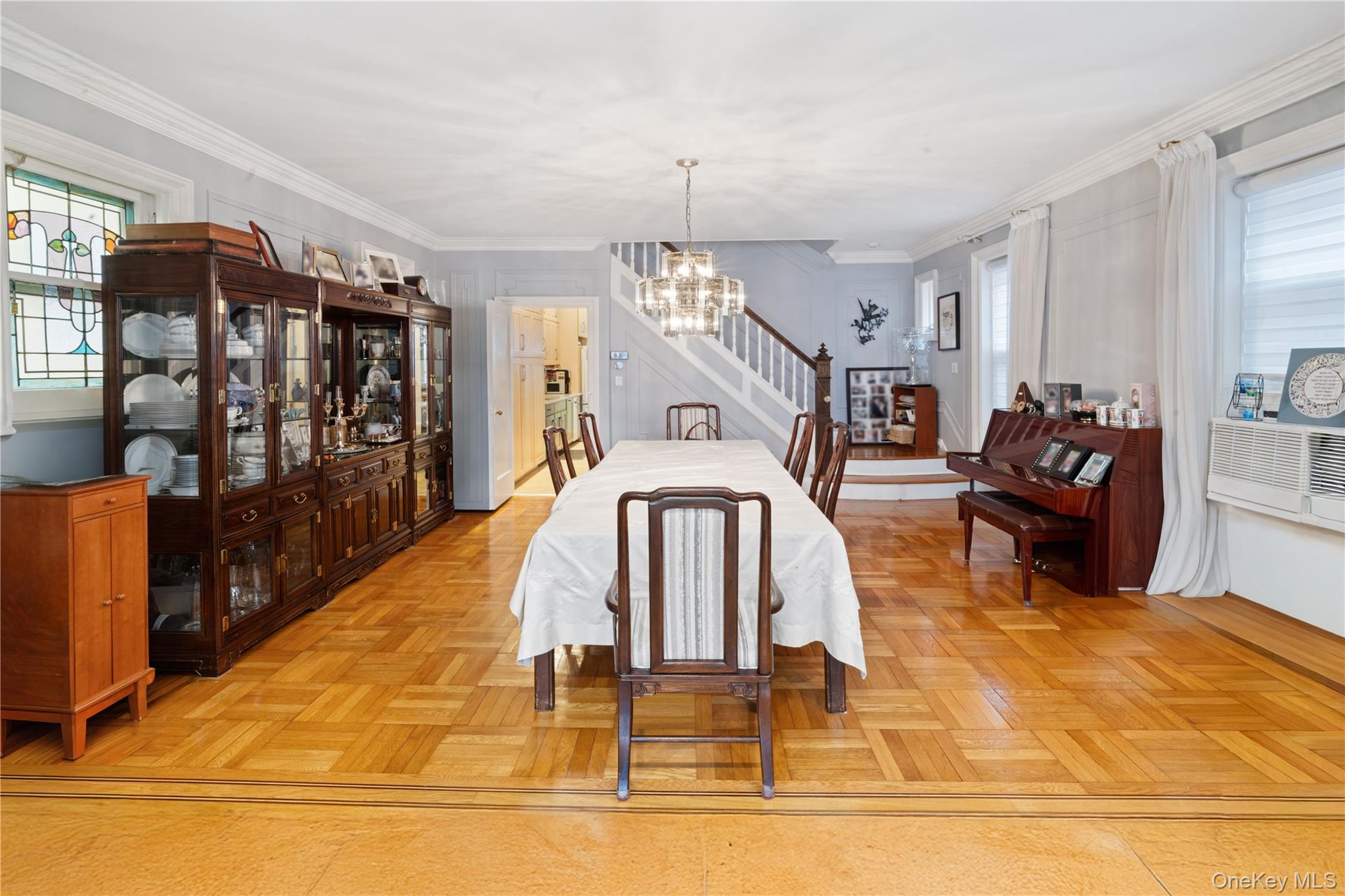 1527 East 29th Street Brooklyn, NY 11229 - Photo 4 of 22 Dining space featuring healthy amount of natural light, crown molding, a chandelier, and cooling unit