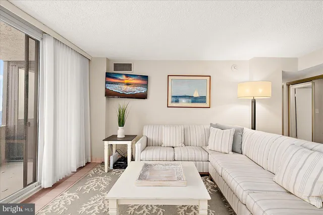 a living room with furniture and a lamp