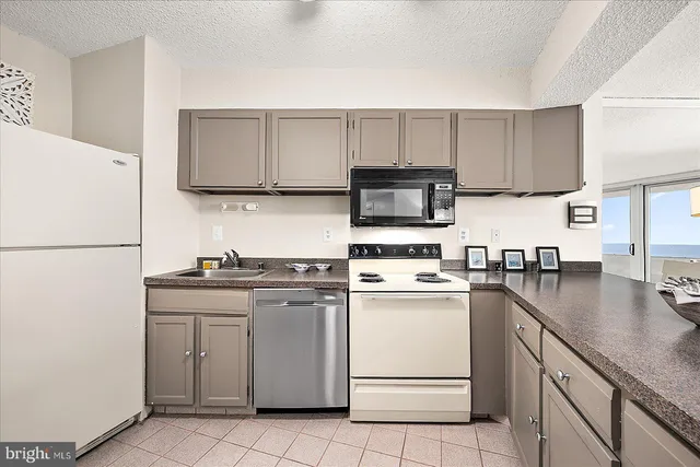 a kitchen with cabinets stainless steel appliances and sink