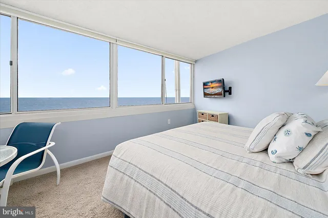 a bedroom with a bed and a chair