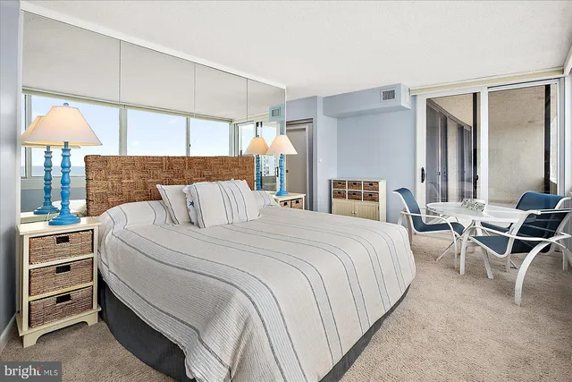 a bedroom with a bed and lamp