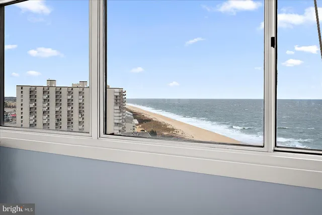 a view of a floor to ceiling window and an ocean view