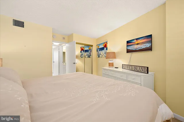 a bedroom with a bed and a large mirror