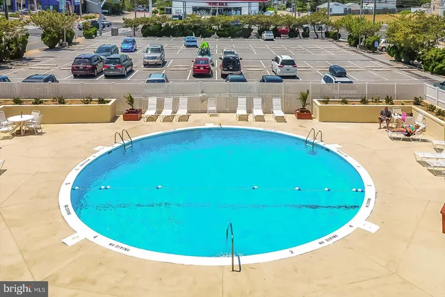 a view of a swimming pool with outdoor seating