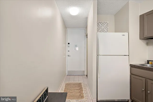 a white refrigerator freezer sitting inside of a kitchen