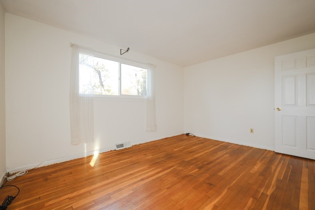 354 Gorwin Drive Holliston, MA 01746 - Photo 15 of 25 an empty room with wooden floor and windows