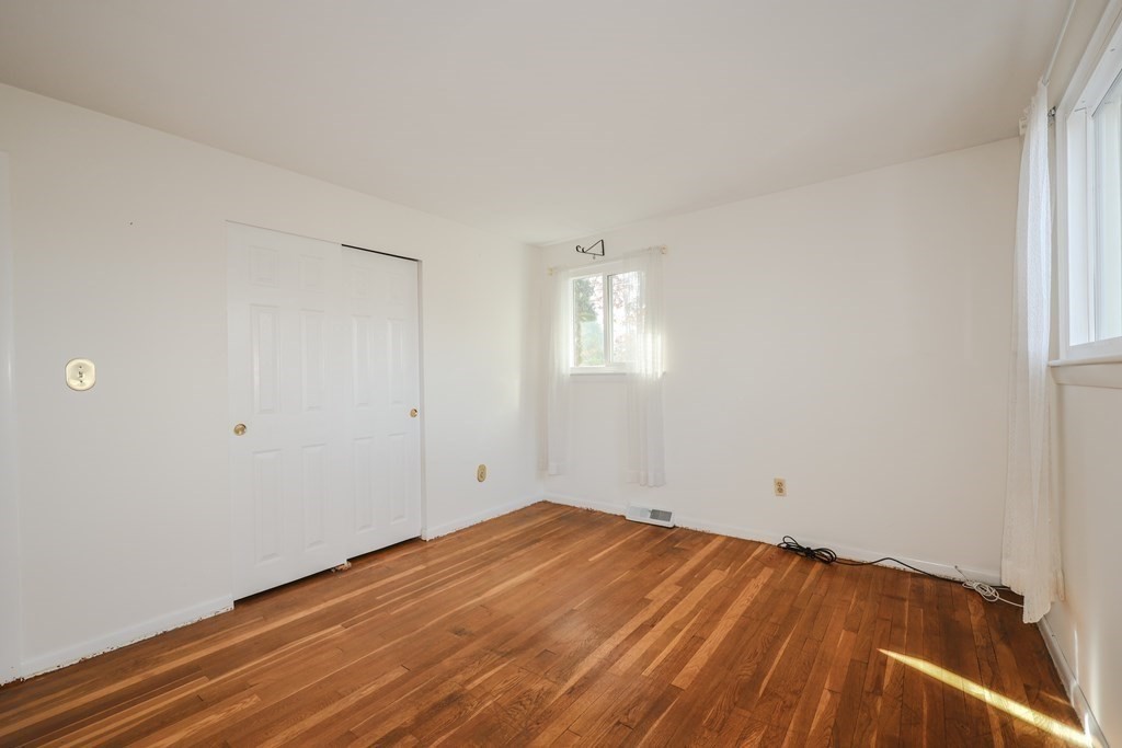 354 Gorwin Drive Holliston, MA 01746 - Photo 16 of 25 a view of empty room with wooden floor and fan