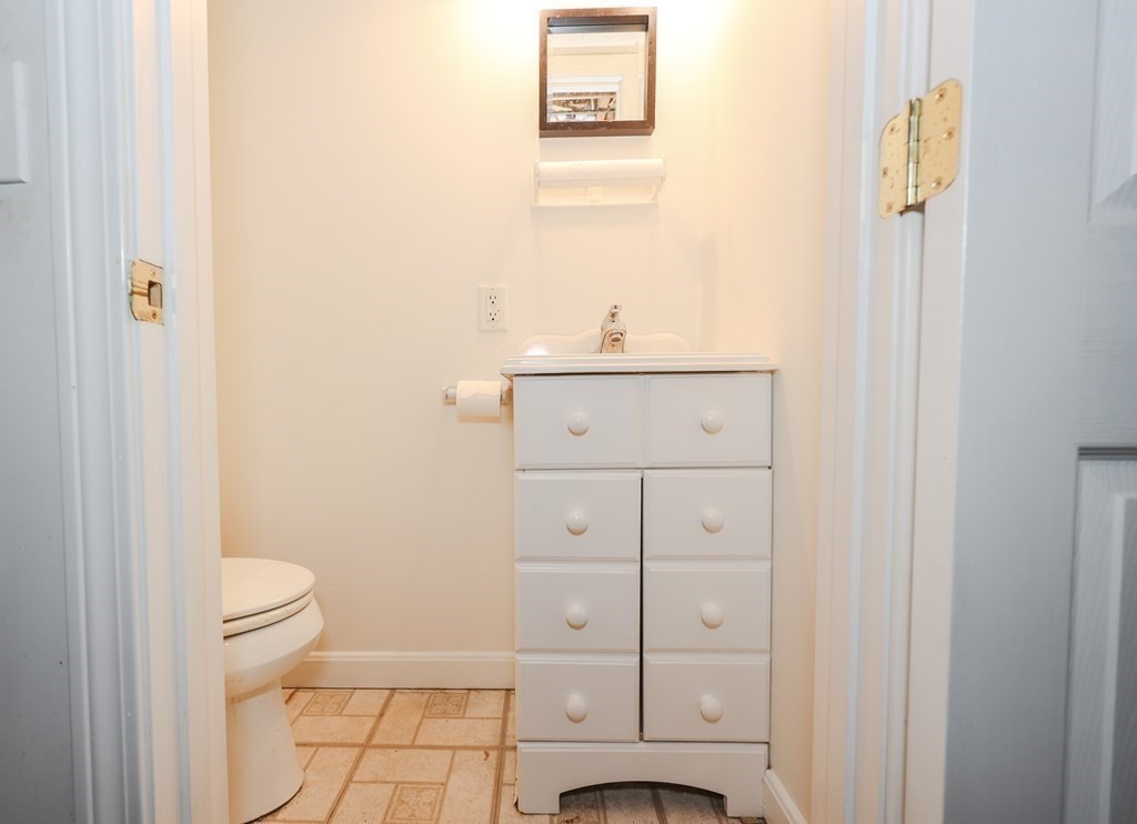 354 Gorwin Drive Holliston, MA 01746 - Photo 23 of 25 a bathroom with a sink a toilet and a mirror