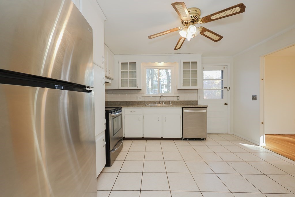 354 Gorwin Drive Holliston, MA 01746 - Photo 4 of 25 a kitchen with stainless steel appliances a refrigerator sink and cabinets