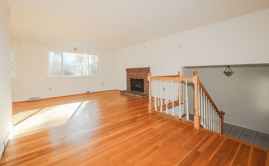 354 Gorwin Drive Holliston, MA 01746 - Photo 9 of 25 a view of a room with wooden floor and windows