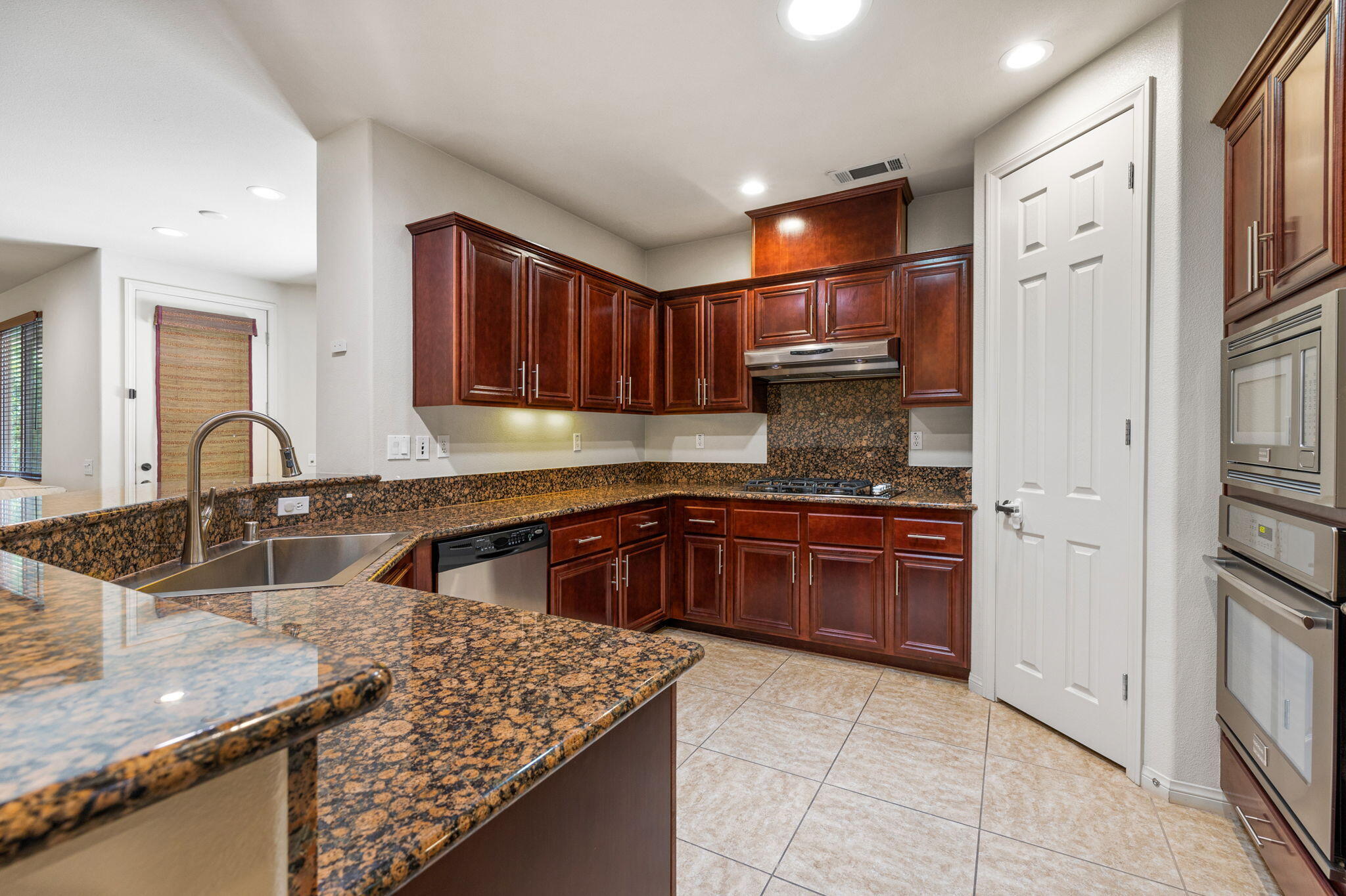 83725 Himalaya Drive Indio, CA 92203 - Photo 16 of 45 a kitchen with stainless steel appliances granite countertop a sink stove and refrigerator