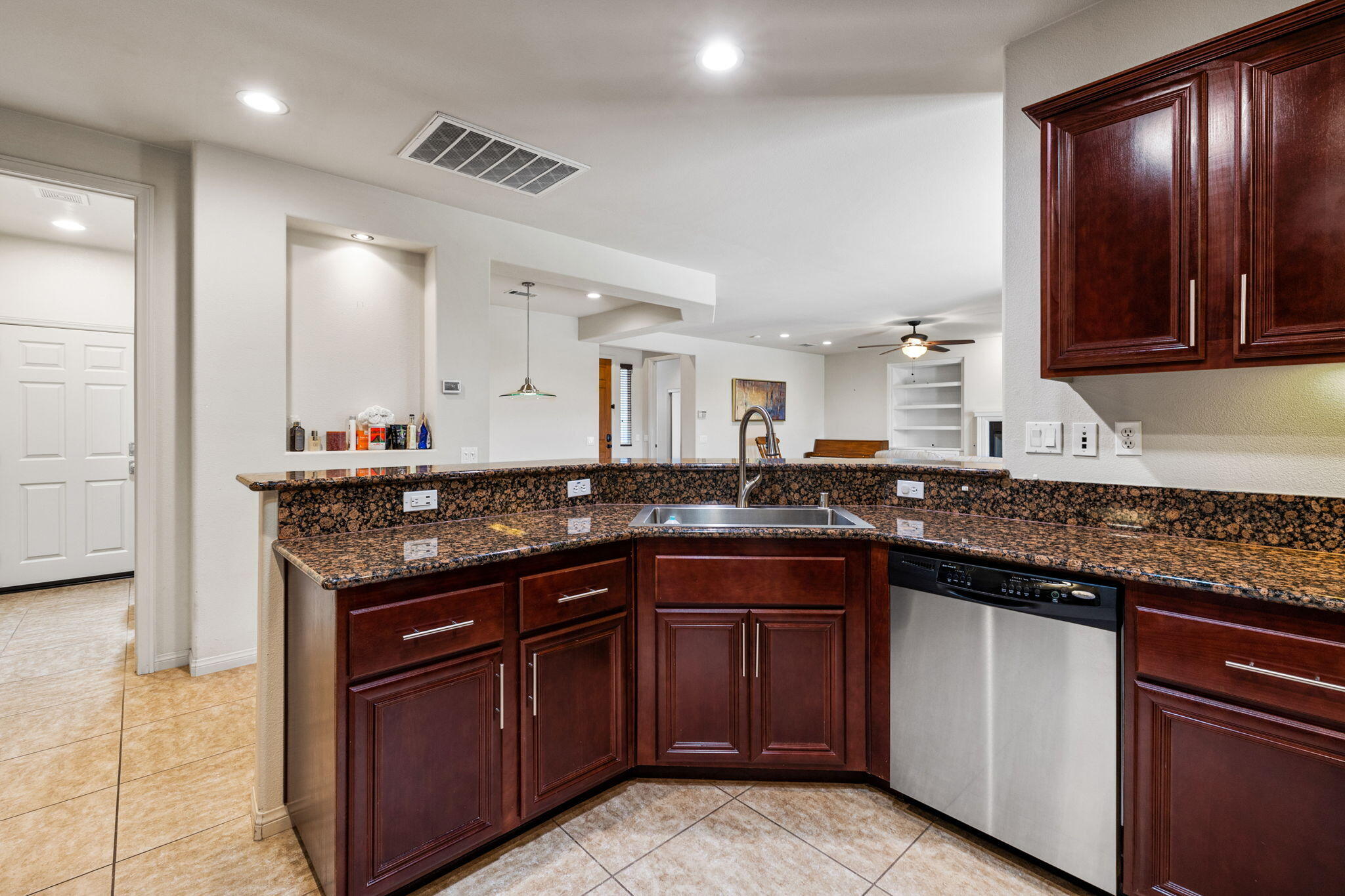 83725 Himalaya Drive Indio, CA 92203 - Photo 18 of 45 a kitchen with kitchen island granite countertop a sink and cabinets