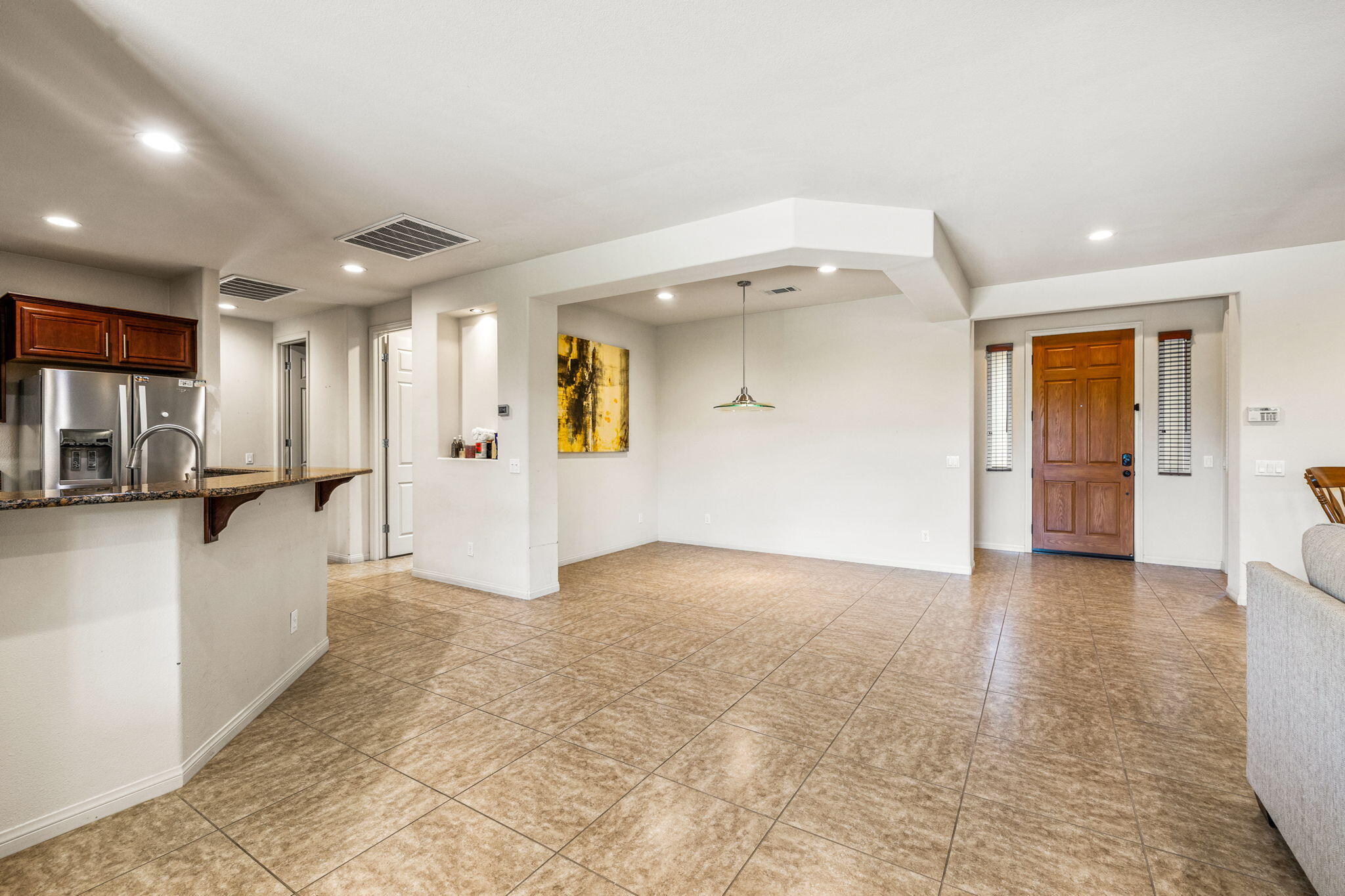 83725 Himalaya Drive Indio, CA 92203 - Photo 29 of 45 a view of a hallway with wooden floor and a living room