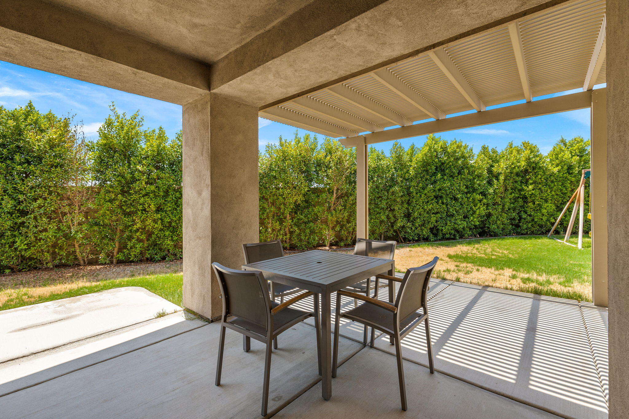 83725 Himalaya Drive Indio, CA 92203 - Photo 34 of 45 a view of a patio with table and chairs under an umbrella