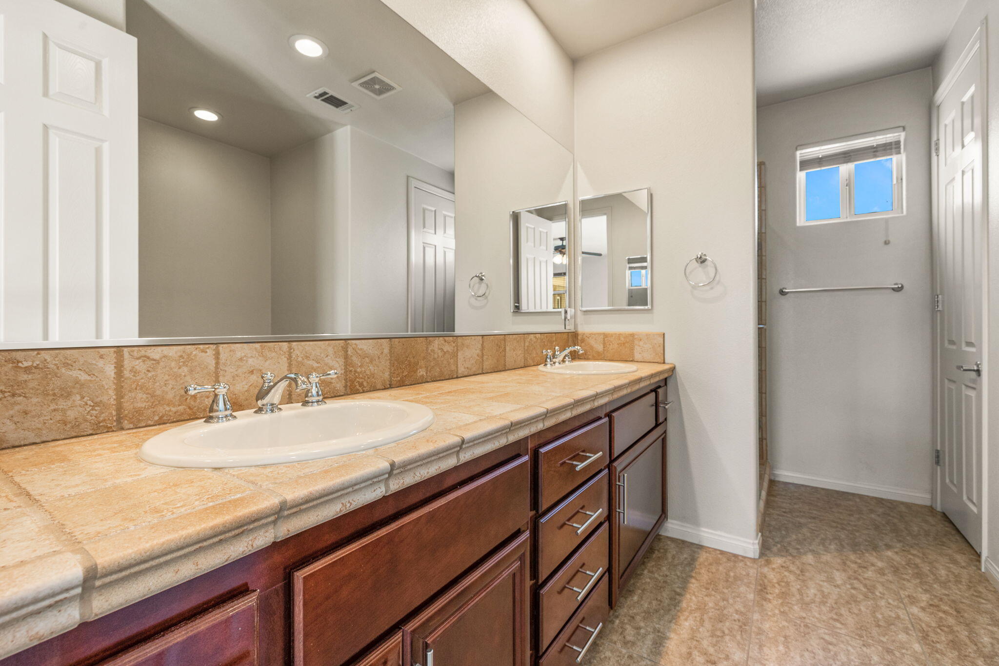 83725 Himalaya Drive Indio, CA 92203 - Photo 6 of 45 a bathroom with a granite countertop sink and a mirror