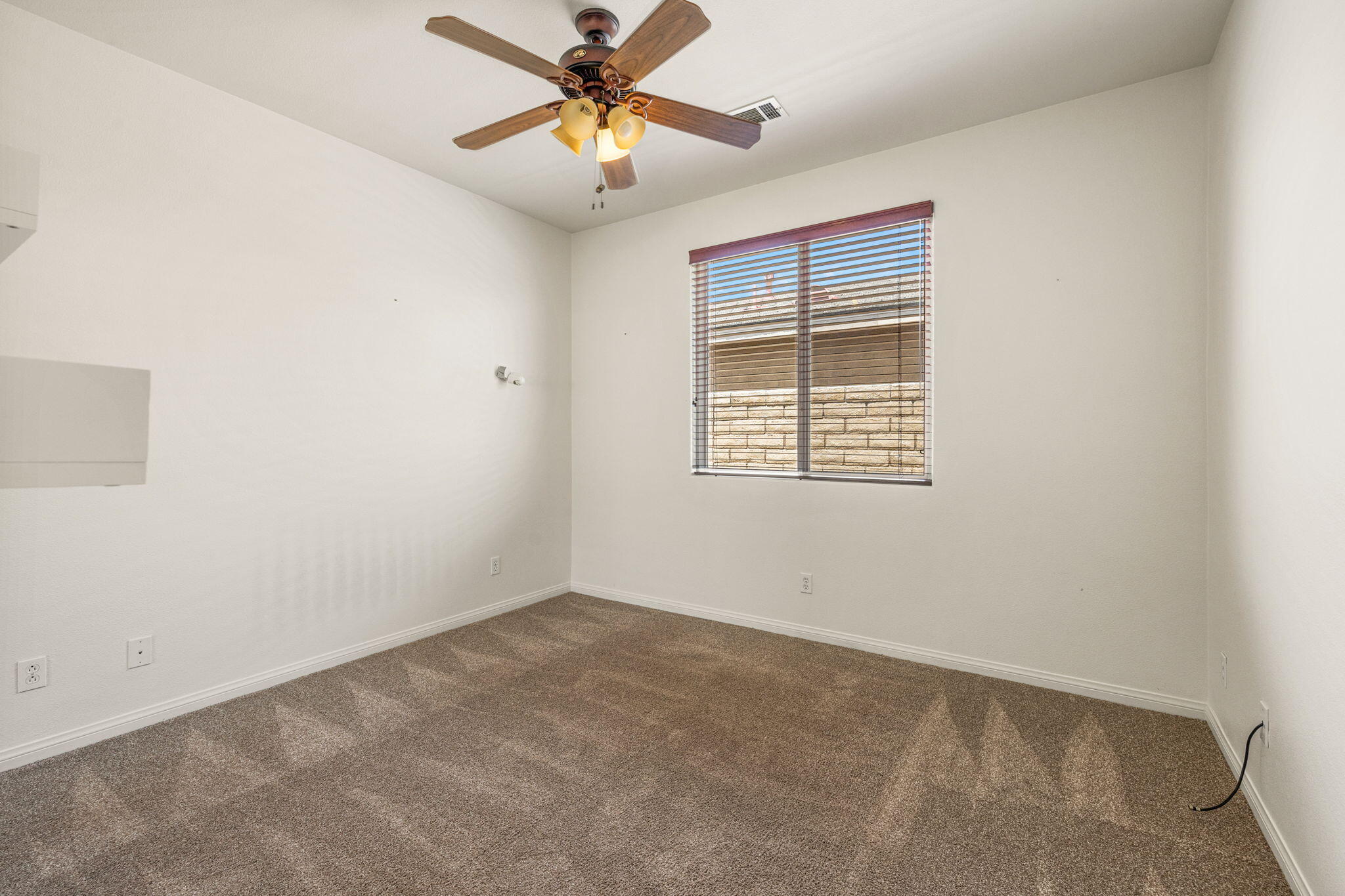 83725 Himalaya Drive Indio, CA 92203 - Photo 9 of 45 an empty room with a window and a fan