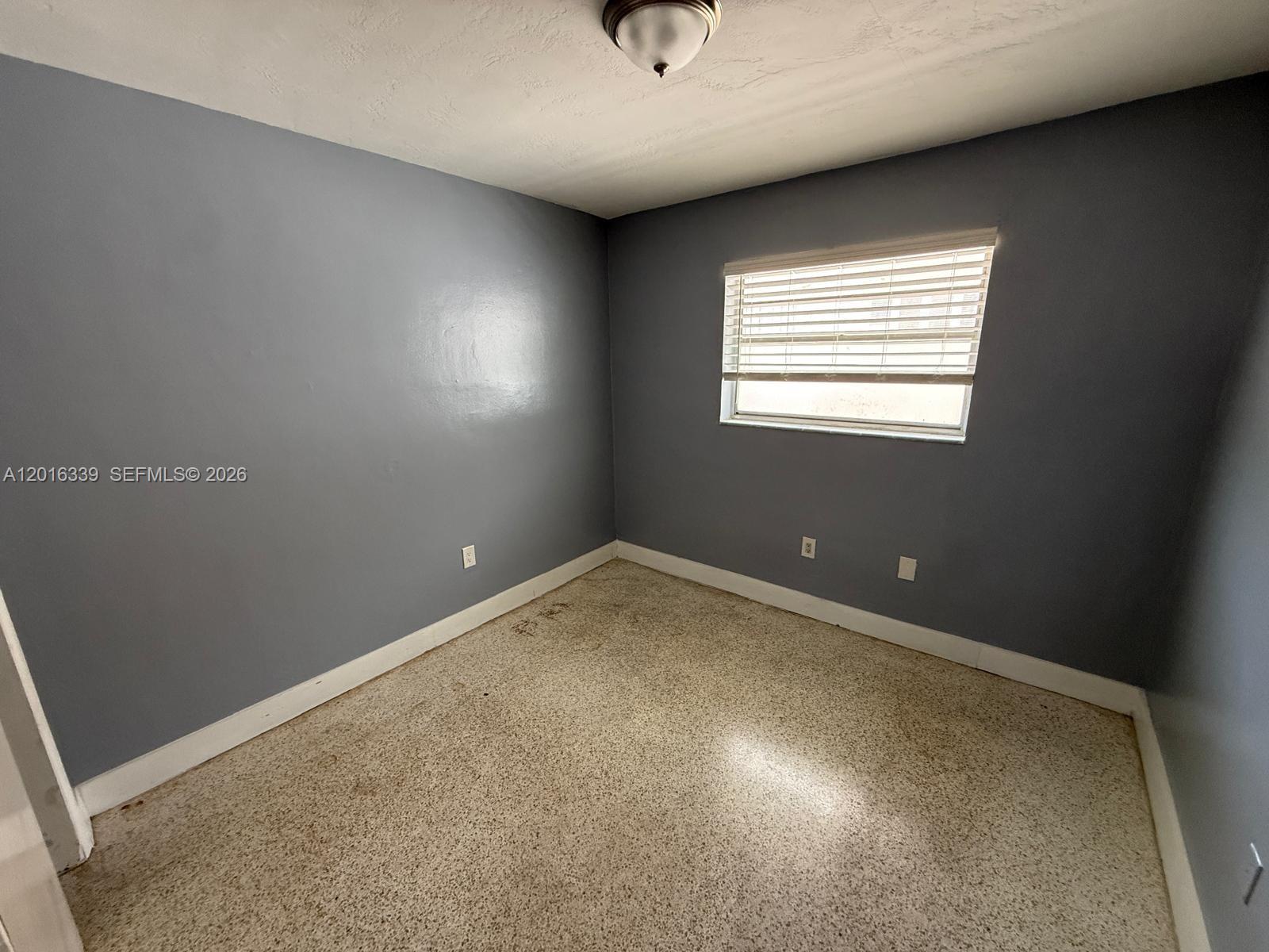 990 Southwest 4th Street, Unit 6 Miami, FL 33130 - Photo 1 of 6 a view of an empty room with a window