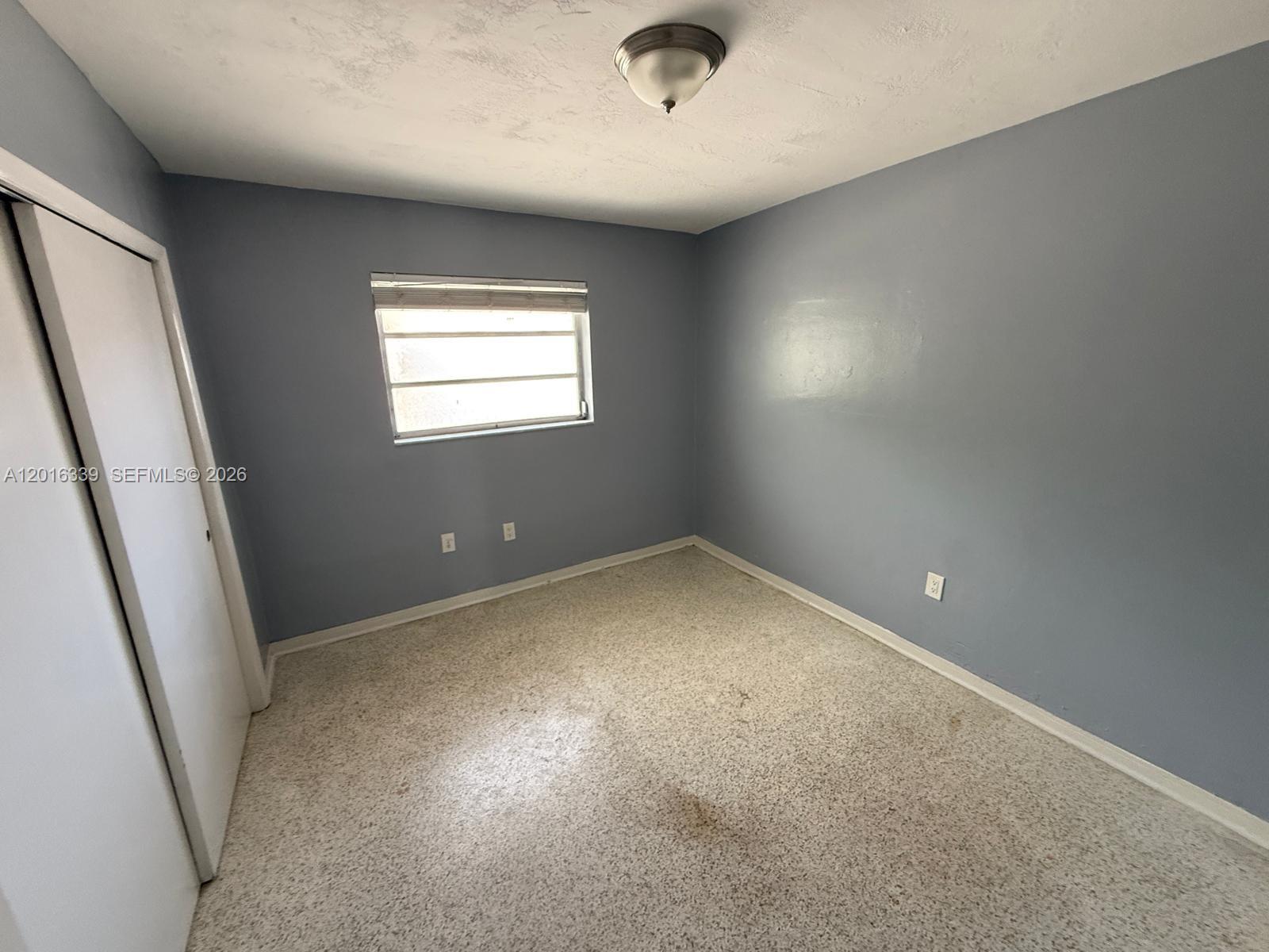 990 Southwest 4th Street, Unit 6 Miami, FL 33130 - Photo 3 of 6 an empty room with a window